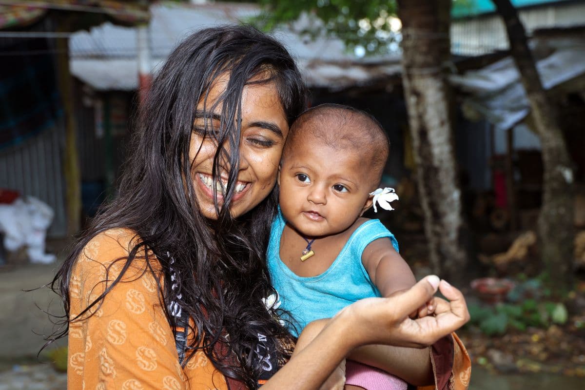 A Bangladeshi mother holding her baby; illustrative stock photo, not an ASOK Foundation gathering
